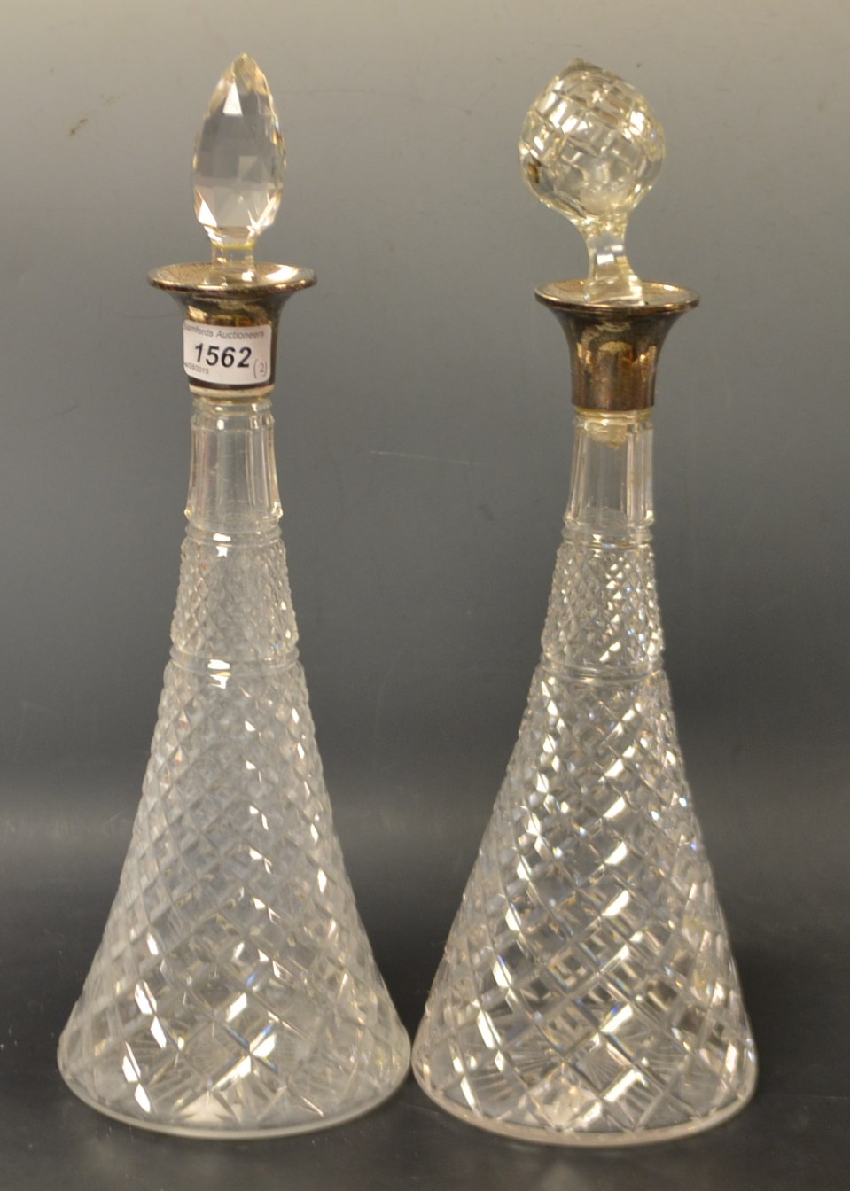 A pair of silver mounted cut glass decanters,