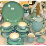 A green Denby dinner service comprising, seven dinner plates, six oval dishes, four side plates,