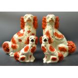 A pair of 19th century Staffordshire spaniels, Pyce coats, gilt collars; another,