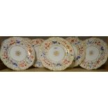 Seven Minton plates with stylized floral decoration in gilt, blue and orange,