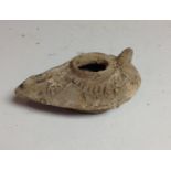 Antiquities - a medieval Persian pottery oil lamp, moulded in low relief with geometric motifs,