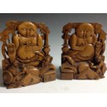 A pair of Chinese sandalwood bookends, each carved with the rotund budai, 15.