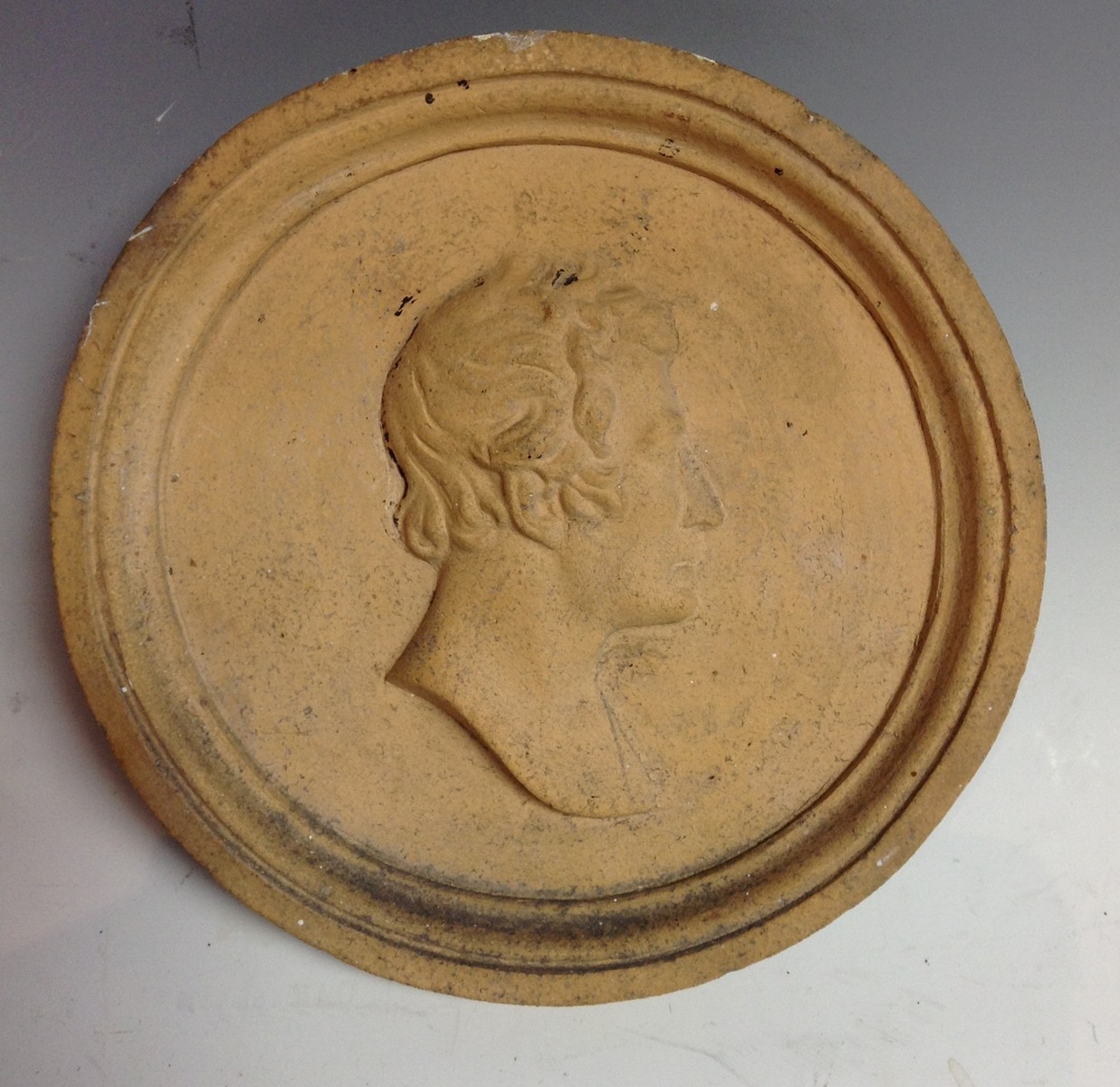 A 19th century earthenware portrait roundel,