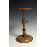 A George III sycamore table top adjustable candle stand, dished circular top turned column,