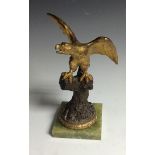 A late 19th century gilt and patinated desk top novelty pocket watch stand, cast as a golden eagle,