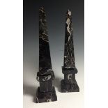 A pair of veined marble obelisks, square plinth bases,