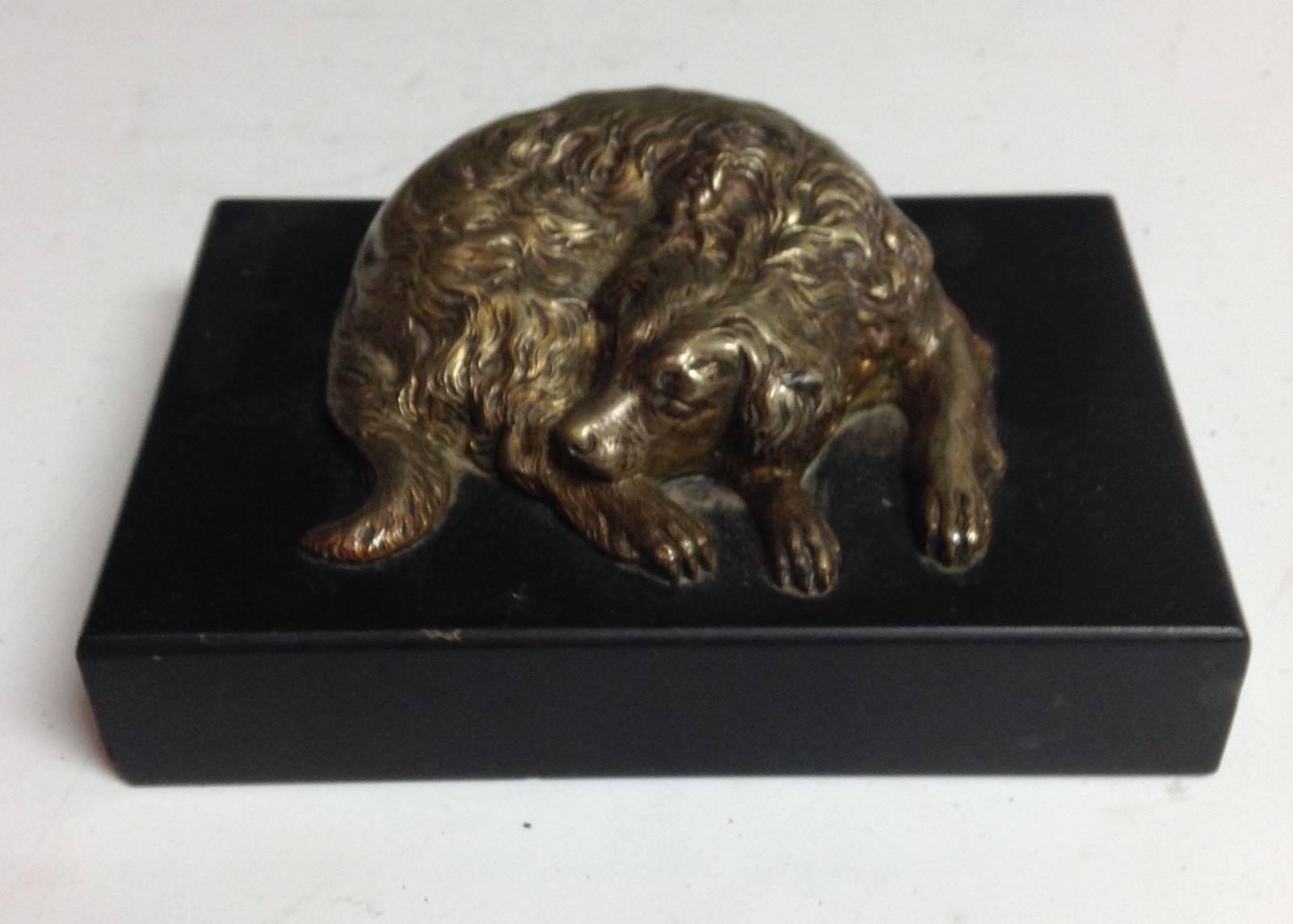 A 19th century gilt bronze desk weight, cast as a sleeping dog, rectangular marble base, 10.