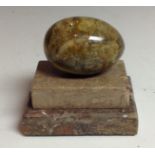 A Derbyshire flurospar egg shaped paperweight, stepped marble base, 9.
