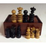 A 19th century English boxwood and ebonised chess set, of ring turned form, the kings 6cm high,