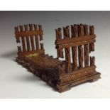 A Black Forest folding bookslide, the end supports carved as rustic gates,