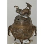 A Japanese bronzed metal elephant handle koro and cover, cast with swooping bird and animals,