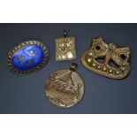 A Scandinavian oval and blue enamelled brooch, the central panel of three crowns,