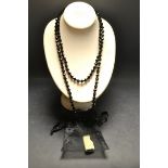 A single strand alternating large and small faceted jet black bead necklace,
