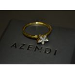 An Azendi diamond five petal flower head ring,