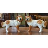 A pair of late Victorian Staffordshire mantel dogs, orange glass eyes, 39cm wide, c.