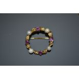 A seed pearl and pink topaz circular wreath brooch, four pearls and four topaz stones alternate set,