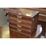 An Edwardian mahogany four drawer desk top correspondence cabinet