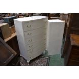 A contemporary white painted bow front chest of six drawers; a white painted blanket box.