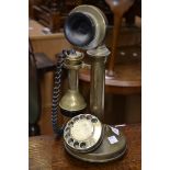 A brass candlestick telephone