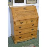 A light oak monastic style bureau, raised dovetail joints to top,