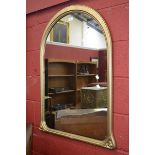 A gilt framed arched wall mirror; another rectangular bevel edge plate,