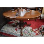 A mahogany loo table, oval top, tapering octagonal column,  three cabriole legs,