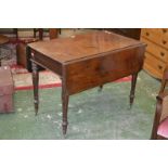 A Victorian mahogany Pembroke table, rounded rectangular top, turned and carved legs, brass casters,