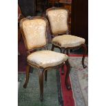 A pair of Victorian walnut salon chairs,