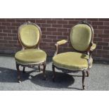 A Victorian mahogany his and hers pair of salon chairs, his with floral cresting oval padded back,