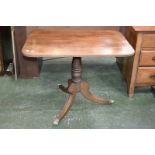A George III mahogany tilt top tripod table, rounded rectangular top, turned column,