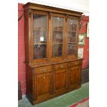 An early 20th century oak display cabinet, moulded cornice, three glazed doors to top,