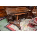 An early 19th century rosewood card table, rectangular top enclosing circular baize playing surface,