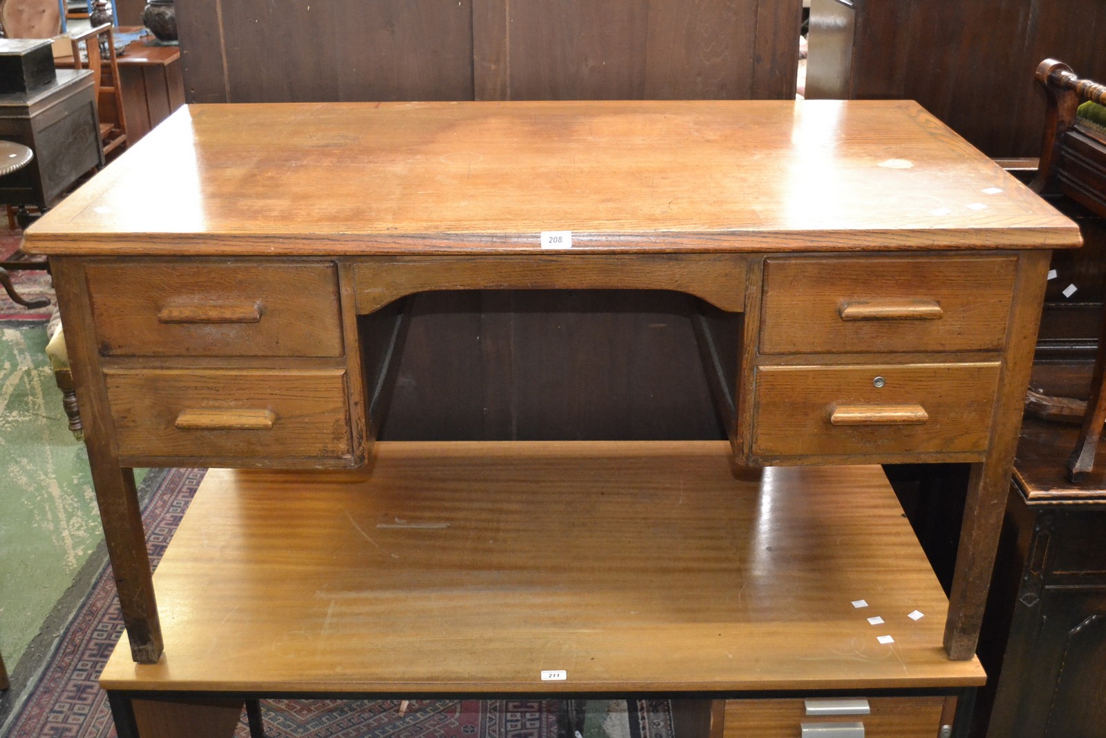 A 1940/50's oak office desk, rounded rectangular top, kneehole flanked by four drawers,