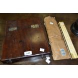 A mahogany box containing drawing instruments, slide rules, etc.