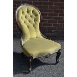 A Victorian mahogany spoon back nursing chair, deep button upholstery,