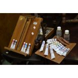 A table top artist's travelling easel with paints, palette, palette knives, etc.