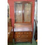 A 1930/40's dome top bureau bookcase, two leaded lights to top, fall front enclosing pigeon holes,