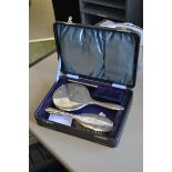 A cased silver dressing table set,