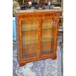 A reproduction yew veneered floor standing bookcase, dentil worked cornice,
