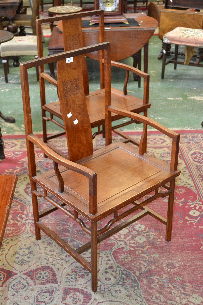 A pair of oriental hardwood armchairs, S-form splat, shaped open arms, panel seat,