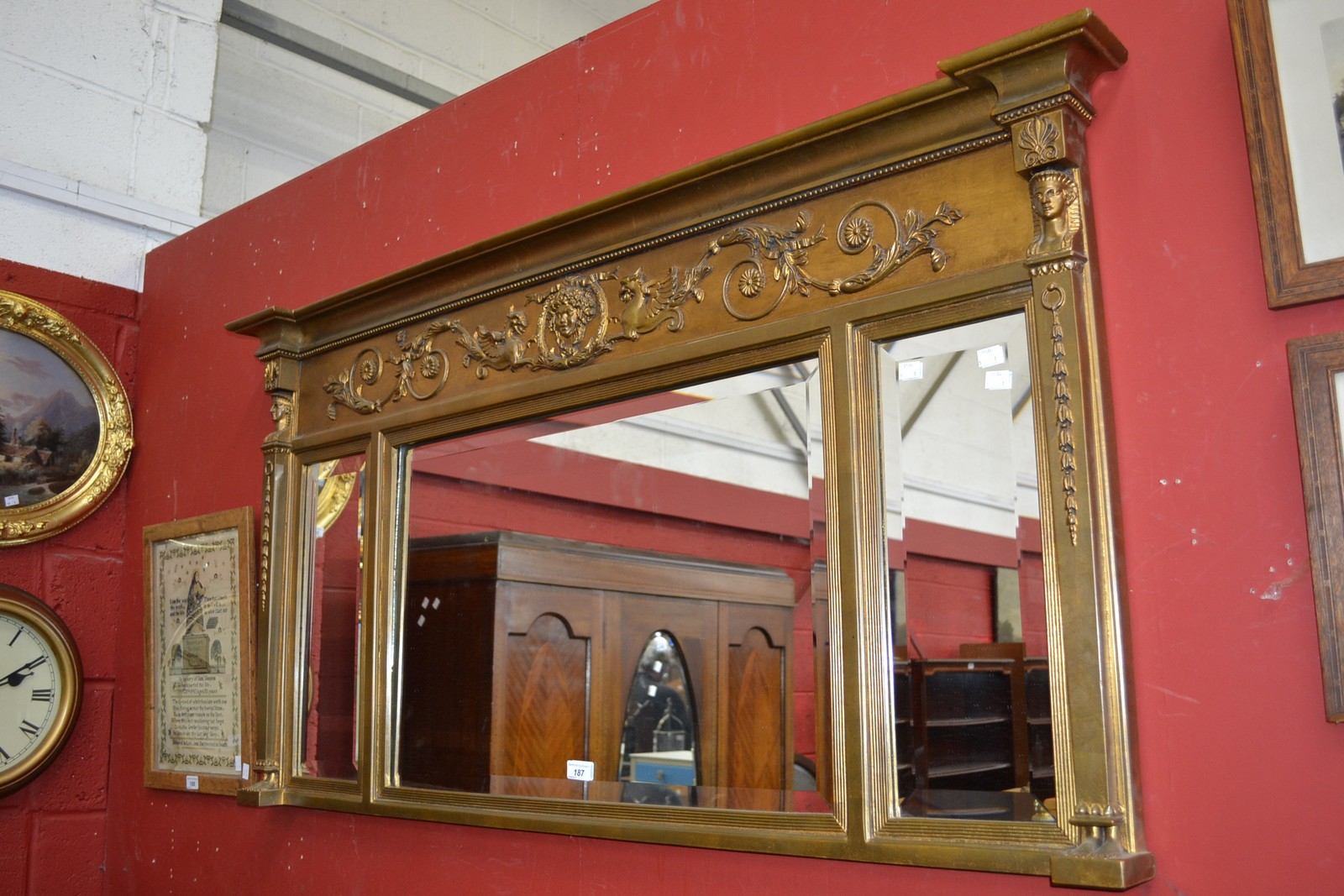 A gilt framed overmantel mirror.