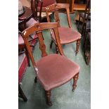 A pair of mahogany salon chairs, curved top rail, shaped and carved splat, stuffed-over seat,