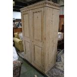 A late Victorian stripped pine hall robe, stepped cornice two panel doors, plinth base.