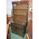 An oak dresser of small proportions, three shelves to top,