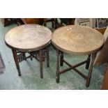Two eastern brass topped folding tables.