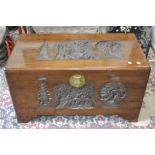 An oriental camphor wood chest, heavily carved throughout.