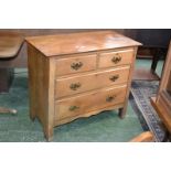 An Edwardian satinwood chest of two short drawers over two long.
