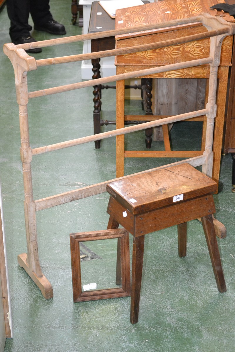 A towel rail; a small oak stool;