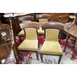 Four William IV mahogany dining chairs, curved top rail, padded back and seat,