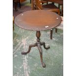 Mahogany tripod table, circular top, baluster column, cabriole legs, claw feet.